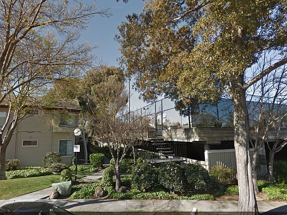 Street View with covered parking entrance. Tennis courts on