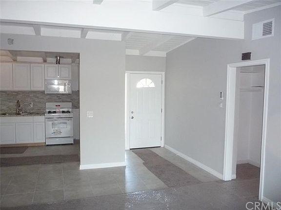 Tile entry, wall to wall carpeting in living room and other rooms.