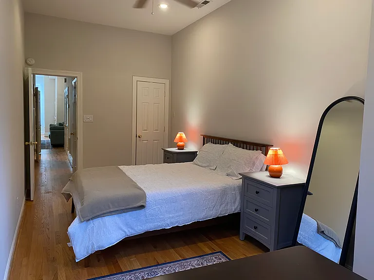 Bedroom #1 features queen bed, ceiling fan, work space