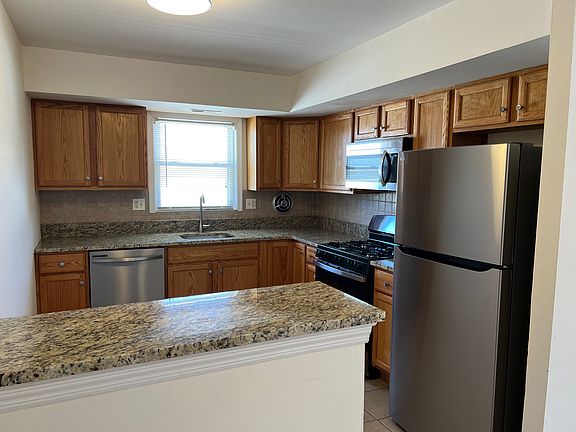Kitchen - brand new stainless steel appliances and granite countertops. Bonus - bar area!