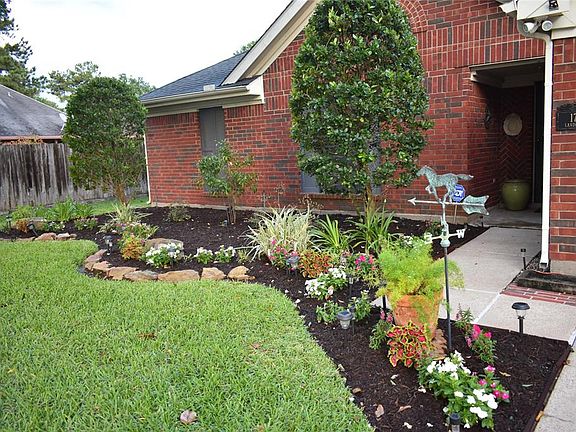 Recent New Mulch in Flower Beds and Freshly Power Washed Driveway and Walk Way to Front Door Welcomes You Home