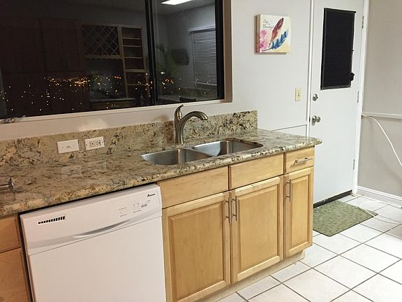 Kitchen, showing dishwasher and view window over sink.