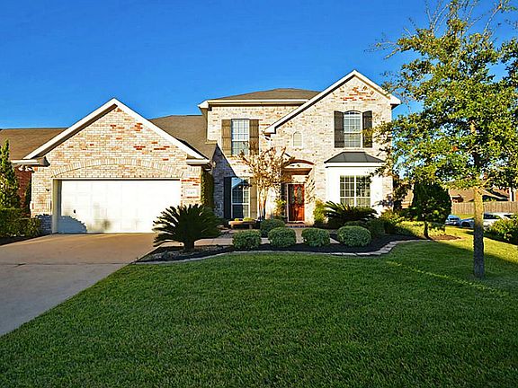 Gorgeous custom landscaping outlines the front entrance to this home Easy to maintain with Rainbird sprinkler systems in both the front and back yard!