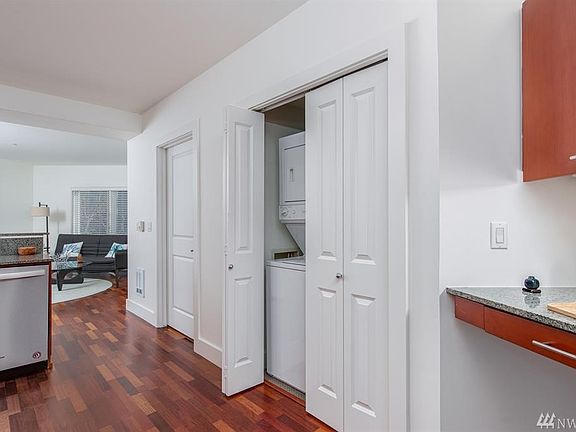 Large utility closet with washer/dryer and electric water heater. 