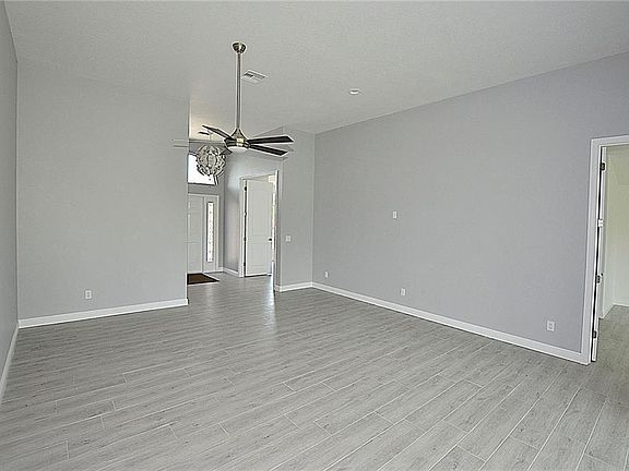 Main living area (taken from the kitchen). Bedroom 2 to the right of entry; master bedroom to the far right of image.