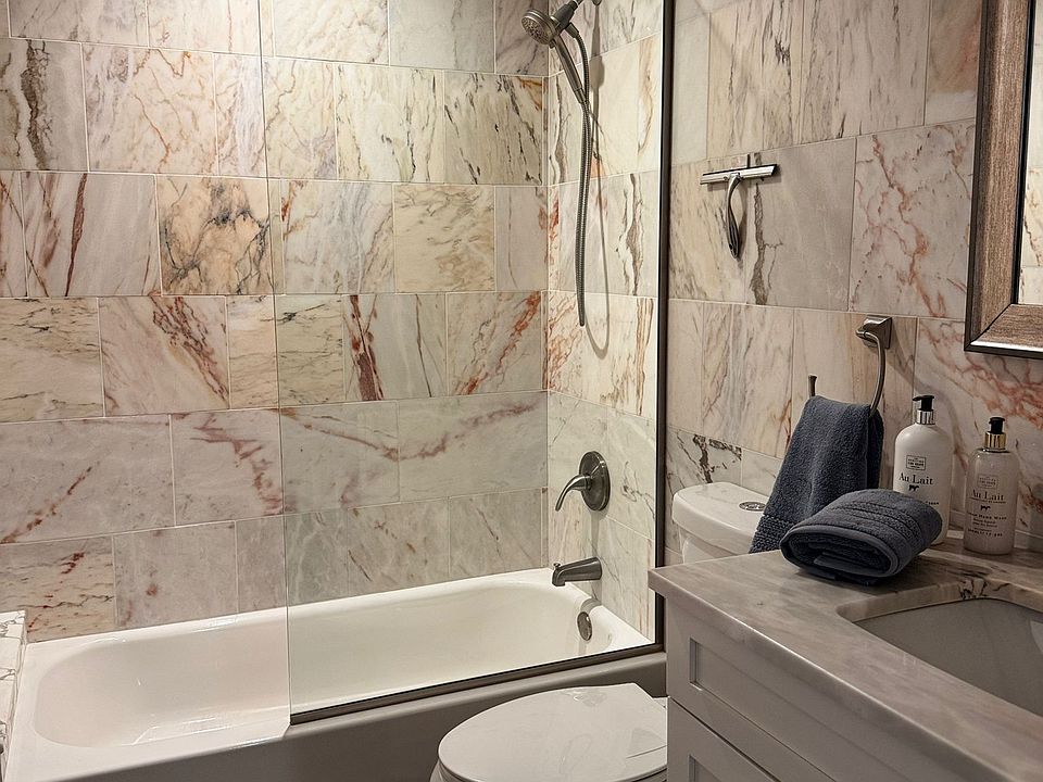 European Marble Tile Bathroom with Tub/Shower and Shower Glass