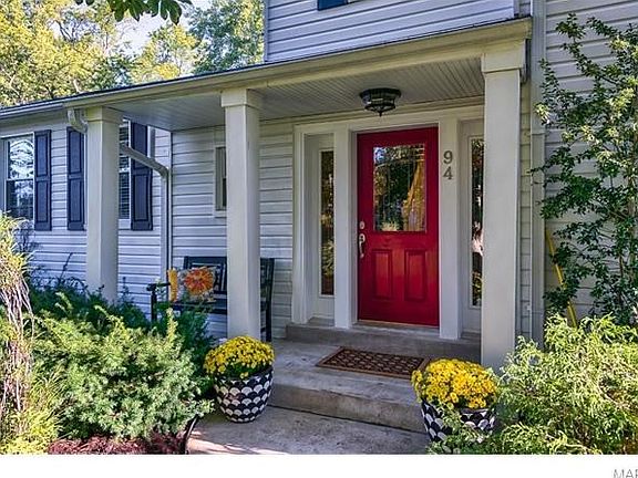 Charming covered front porch greets guests
