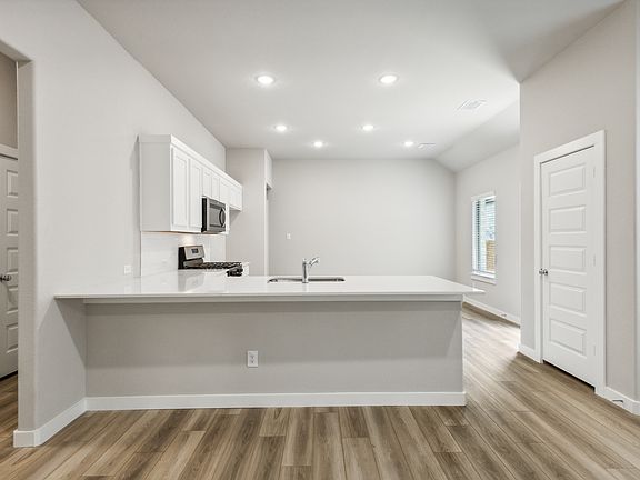 Kitchen in the Pecan home plan by Trophy Signature Homes - REPRESENTATIVE PHOTO