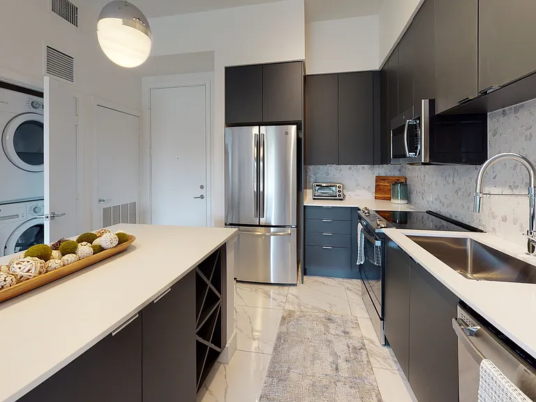 Gourmet kitchens with quartz countertops, modern light fixtures and stainless-steel appliances