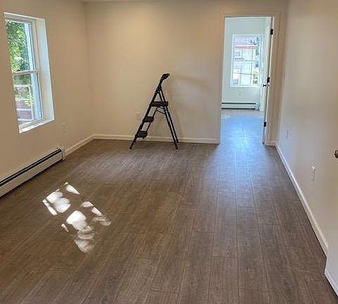 Living area as seen from kitchen. Bedroom, through the door, faces the street.