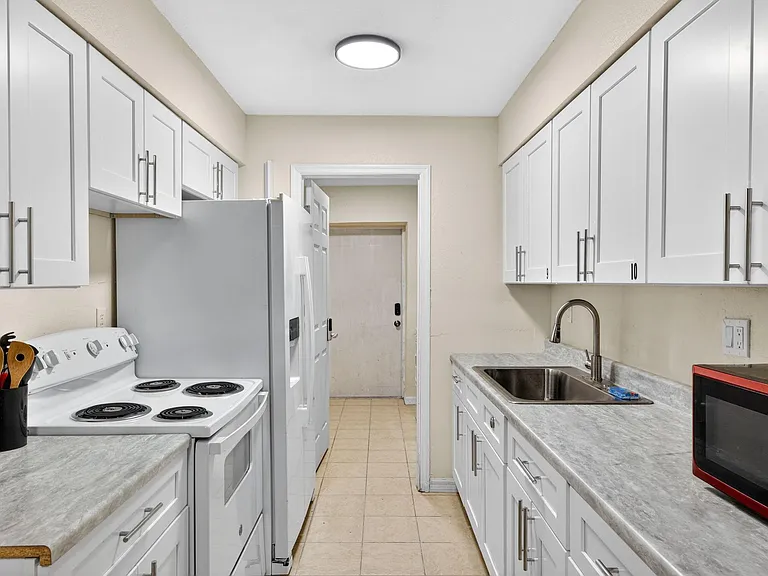 Kitchen Appliances include Stove, Refrigerator / Freezer & Microwave