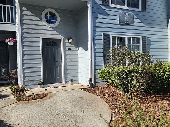 Street level entry to garden level condo. Notice butterfly & rosemary bushes in the front.