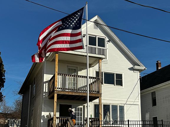 Front of this outstanding Multi-unit home. Balcony accessible from 2nd floor bedroom. Beautiful Patio with seating area! Great place to enjoy morning coffee or work from home!