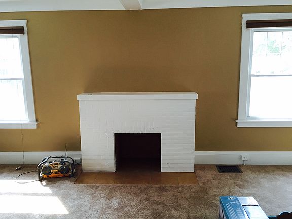 Familyroom sid view of fireplace with fresh earth toned pain