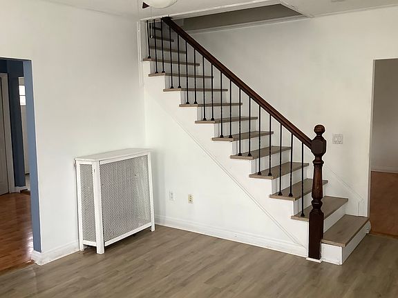 New flooring was installed in the living room and on the stairs. The stairs have wrought iron balusters.