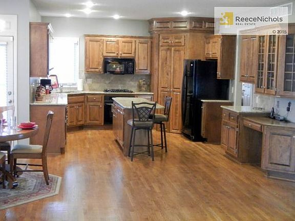 Chef's kitchen with granite counters, tons of cabinets, walk-in