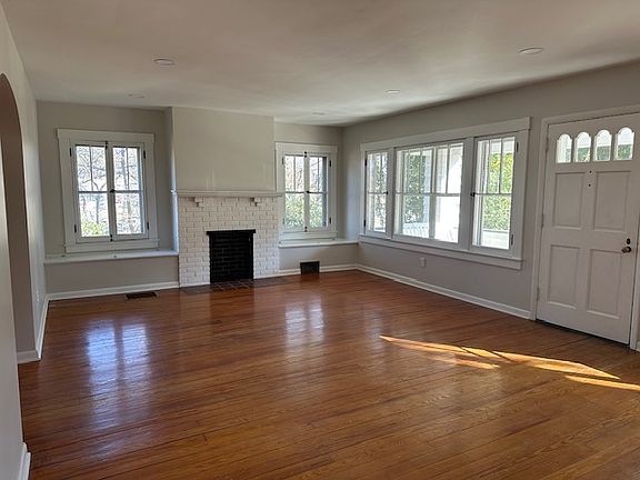 Living room with decorative fireplace, built-in benches and abundant natural light.