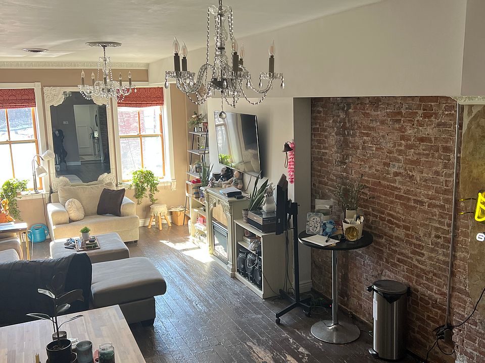 Front living and dining area looking over Sidney Street from 2nd floor. Photo taken from stairs to 3rd floor.