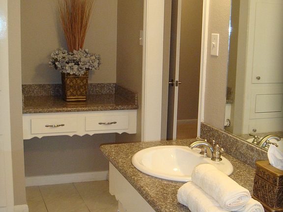 Relaxing Master bathroom with granite countertop