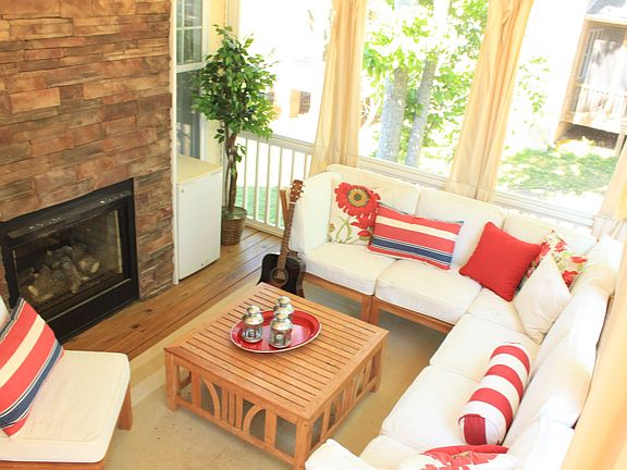 Screened in back porch with fireplace