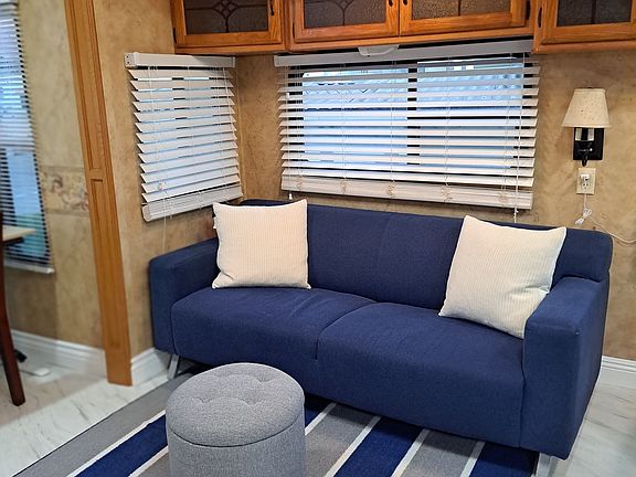 Living area couch. All windows in the RV have faux blinds.