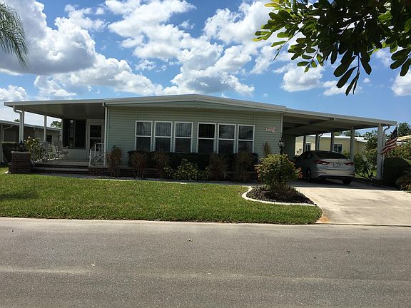 Front of House with Carport