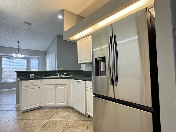 Newer refrigerator, low maintenance tile flooring