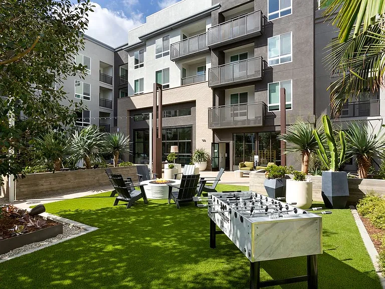 Building B courtyard lounge with gaming, fireplace and lounge seating
