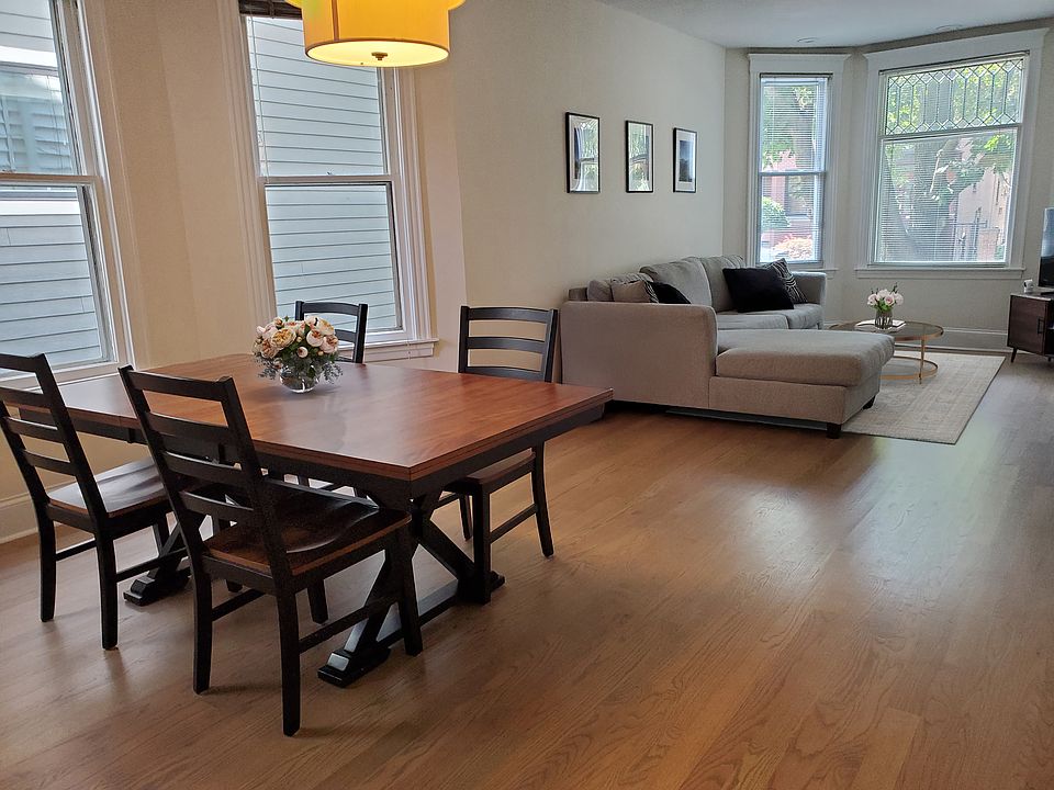 Living/dining room with 2 bay windows and gorgeous new hardwood flrs