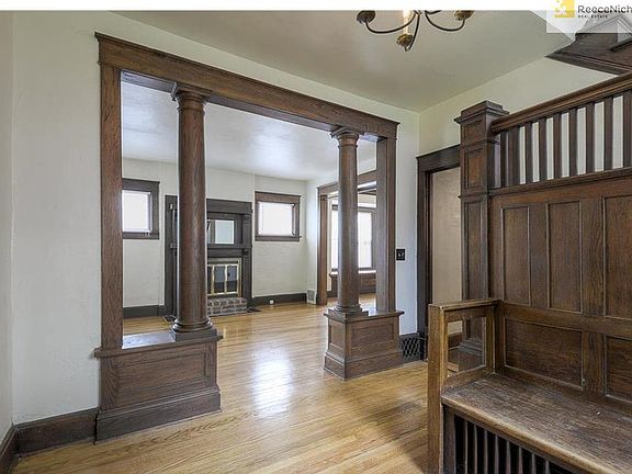 Large entry surrounds you with original, warm woodwork.