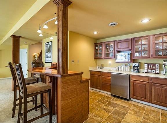 Awesome cherry wood wet bar in wet bar, great for entertaining