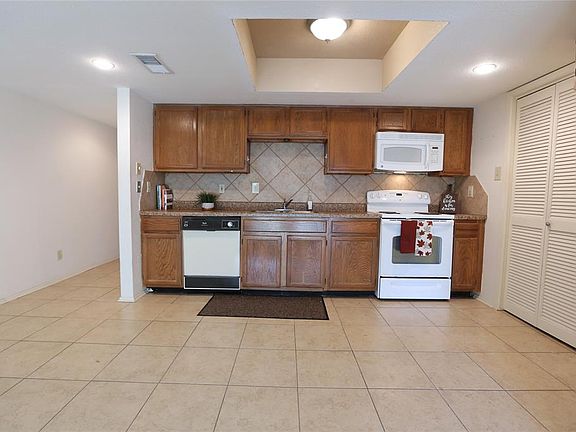 The ktichen/breakfast area is tiled for easy clean up. To the right is the laundry room and pantry.