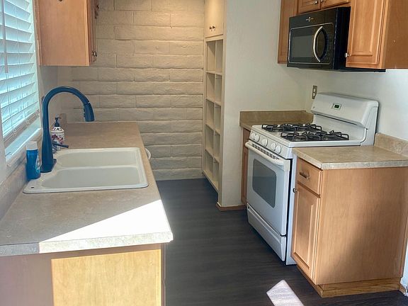 Kitchen with Gas Stove, Microwave, Dishwasher, and Garbage Disposal.