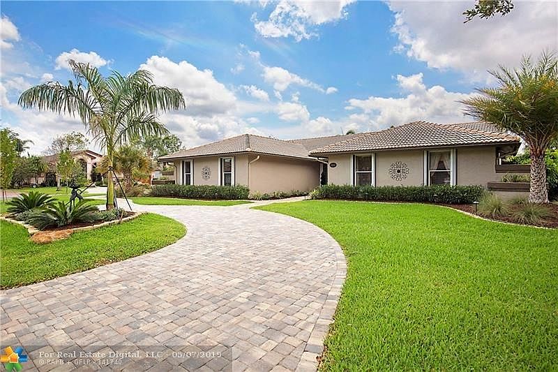 The moment you drive up, you know this home is SPECIALl!  Spectacular curb appeal includes: brand new landscaping, trees, newly installed pavers on the sidewalks, circular and side driveways plus river rock and slate garden accents. Not just pretty, but storm safe, too with a newer roof, accordion shutters and a generator receptacle.