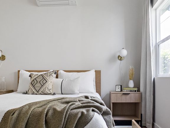 Rest peacefully on this Queen-sized bed, outfitted with high-quality, crisp linens to ensure a deep and comfortable night's sleep. Ample under-bed storage is also available for your convenience.