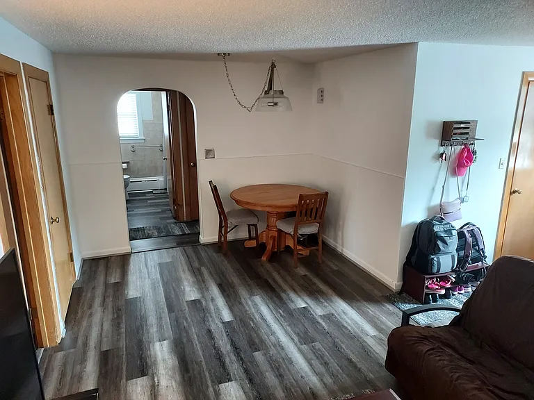 Living/Dining room w/ new flooring throughout.