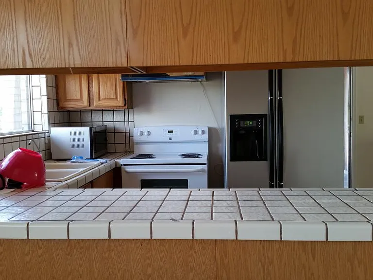 Kitchen with stove, refrigerator, and microwave