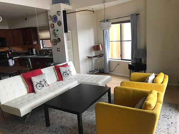 Huge, light-filled living room kitchen combo. High ceilings.