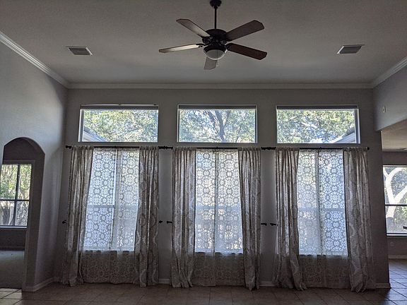 Large windows in living room, kitchen, and master bedroom overlook park-like backyard (you are welcome to change out the curtains).