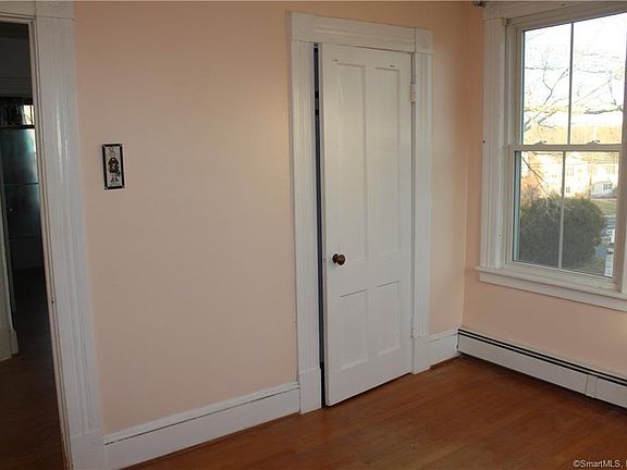 Bedroom 3. Walls, trim and ceiling in this picture are or will be freshly painted by move in date. Floors will be sanded and refinished prior to move in date as well. All windows will have new mini-blinds installed.