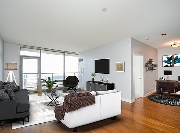 Living room has fabulous view across the balcony and is open to the den and the dining area.
