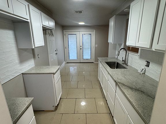 full kitchen view, oven, microwave over the oven and refrigerator with ice and water to be installed
