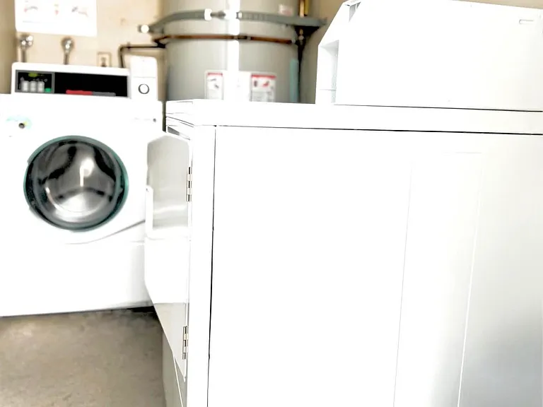 Laundry behind unit beside your garage and designated parking space.