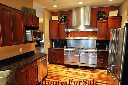 Kitchen has a commercial Vulcan stove with six burners, double oven and griddle.