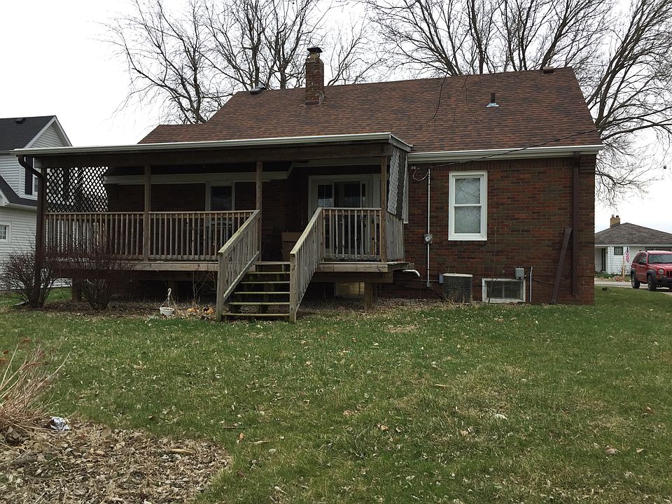back of house with covered d