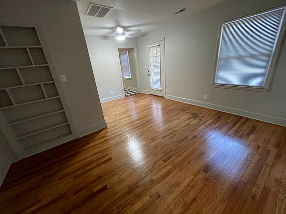 The view of the Living Room looking toward the entry door. Notice additional built-in cabinetry, another view of the refinished hardwood floors.
