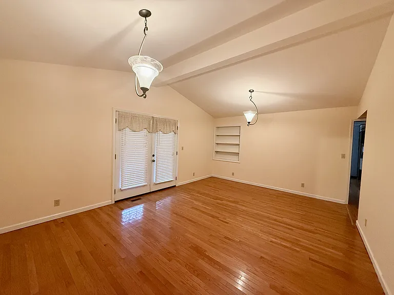 Spacious living room with French doors to the covered front porch.