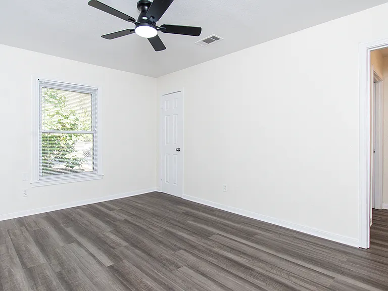 Living room and entrance to hallway with bathroom and bedroom