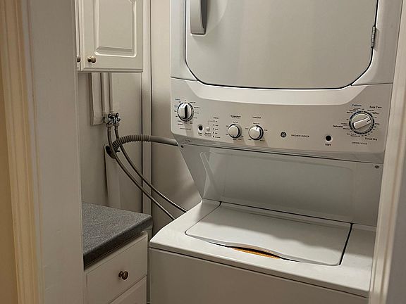 New Washer & Dryer with storage cabinets in hallway