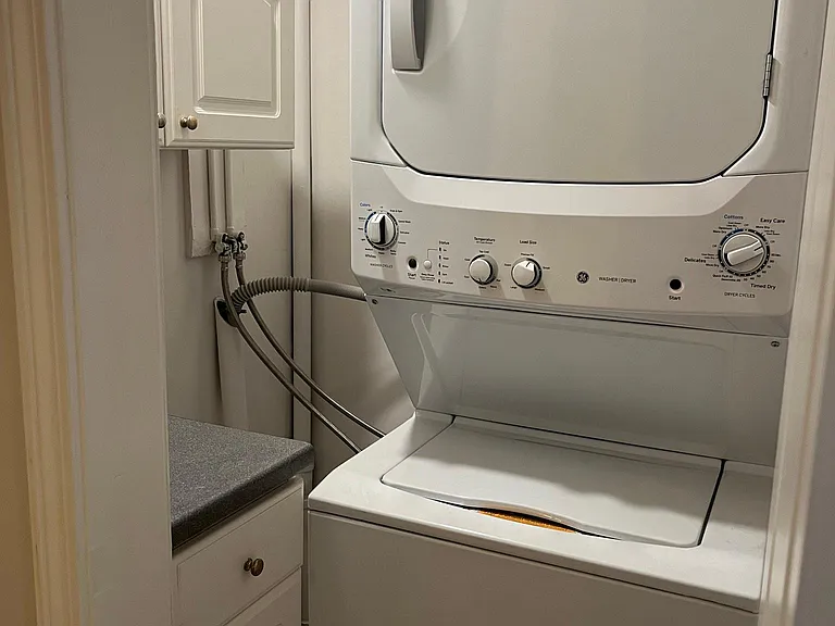 New Washer & Dryer with storage cabinets in hallway